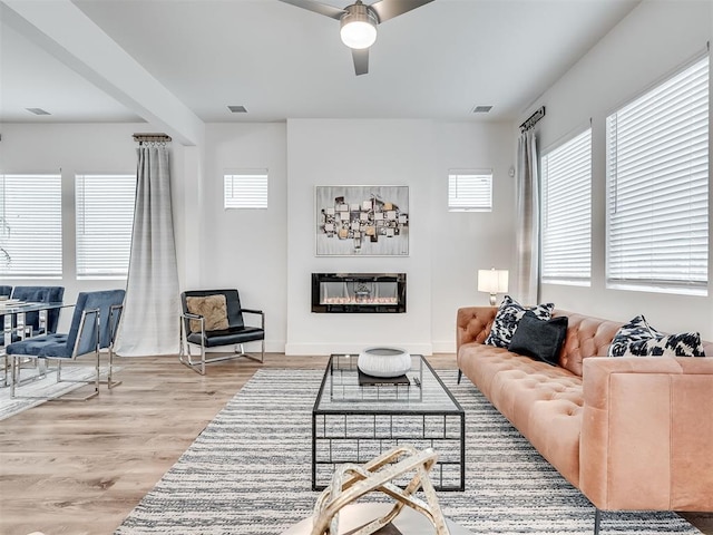 living room featuring light wood-type flooring and ceiling fan