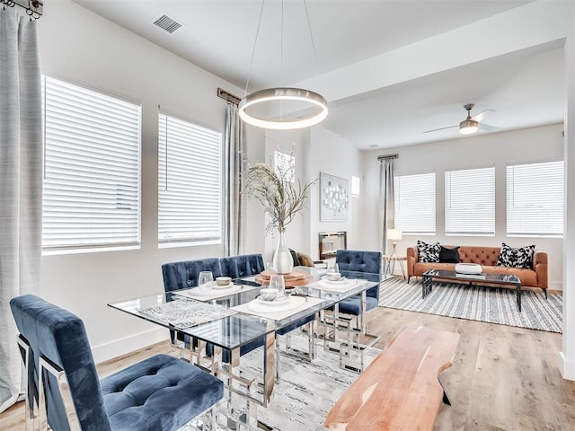 dining space with ceiling fan and hardwood / wood-style floors