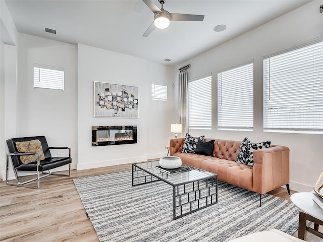 living room featuring ceiling fan and hardwood / wood-style floors