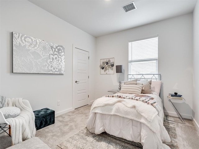 bedroom featuring light carpet