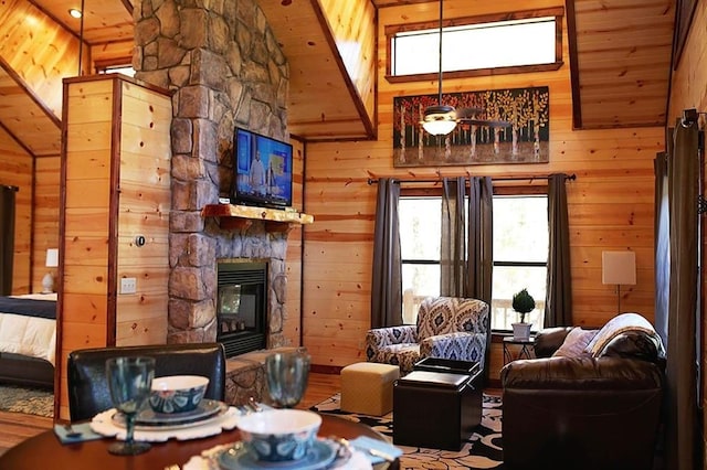 living room featuring a fireplace, wood-type flooring, and wood walls