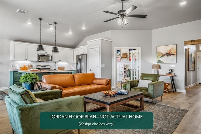 living room with light hardwood / wood-style floors, ceiling fan, lofted ceiling, and sink