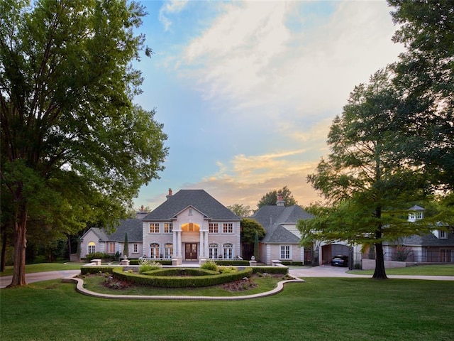 french country home with a lawn