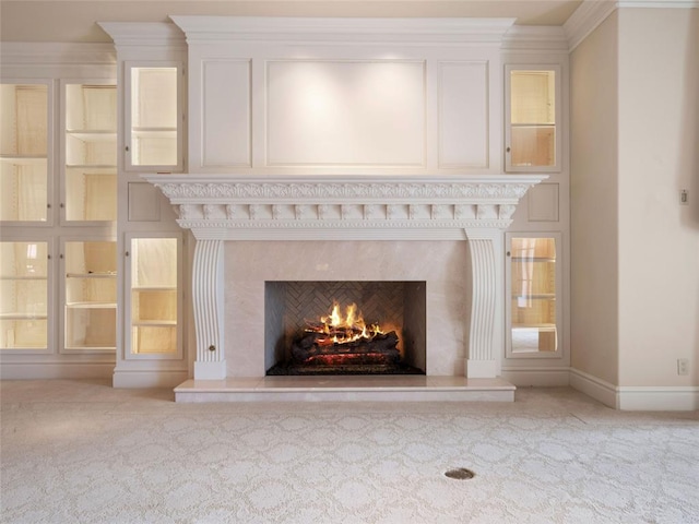 interior details with a premium fireplace, crown molding, and carpet floors