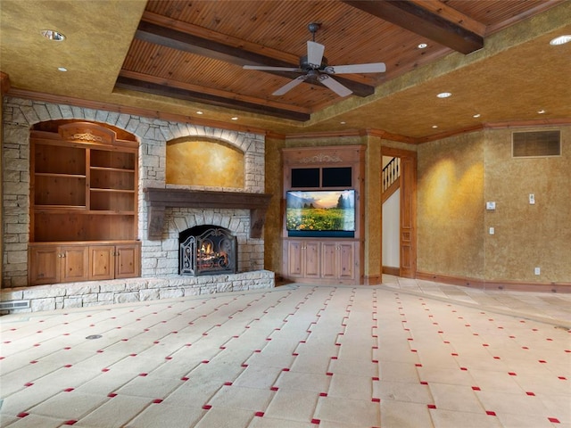 unfurnished living room with ceiling fan, wooden ceiling, a raised ceiling, built in features, and a fireplace