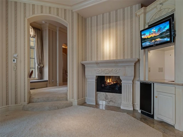 unfurnished living room featuring crown molding