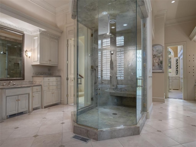 bathroom featuring vanity, a healthy amount of sunlight, a shower with door, and ornamental molding