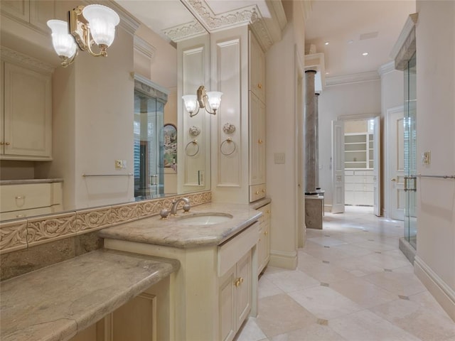 bathroom featuring vanity, ornamental molding, and an inviting chandelier