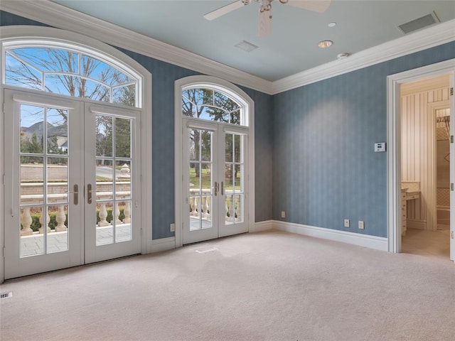 doorway to outside with a healthy amount of sunlight, light colored carpet, and french doors