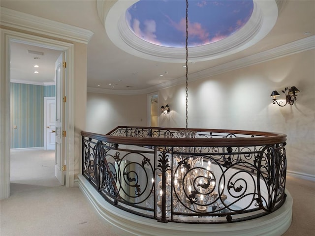 interior space featuring a chandelier, carpet floors, a tray ceiling, and crown molding