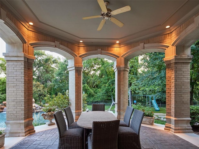 view of patio with a playground and ceiling fan