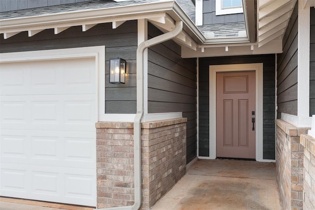 view of exterior entry with a garage