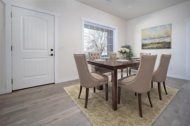 dining space with light wood-type flooring