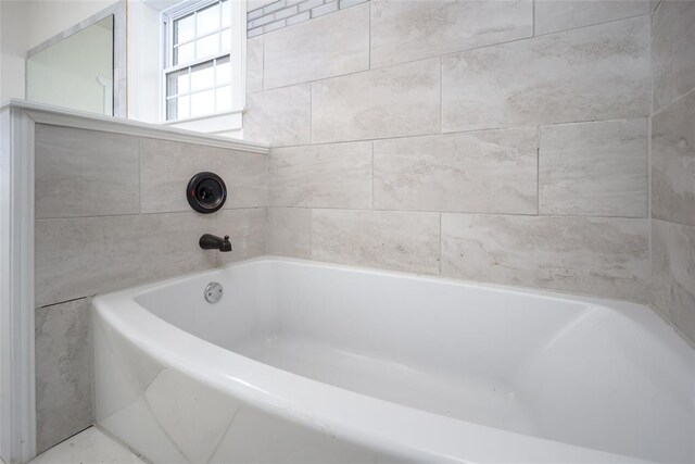 bathroom with a tub to relax in