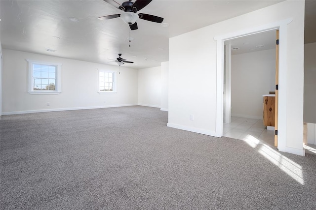 carpeted spare room featuring ceiling fan