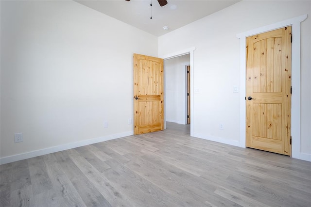 unfurnished bedroom with ceiling fan and light hardwood / wood-style flooring