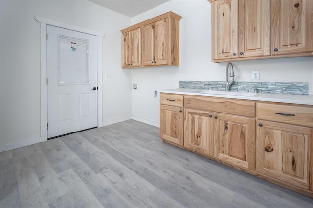 kitchen featuring sink, light brown cabinets, and light hardwood / wood-style flooring