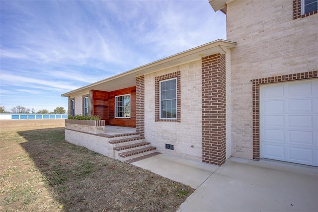 doorway to property with a garage