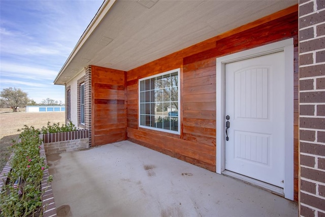 property entrance featuring a patio area