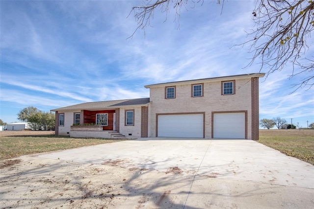 view of front of home with a front lawn and a garage