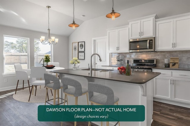 kitchen featuring stainless steel appliances, sink, white cabinets, hanging light fixtures, and lofted ceiling