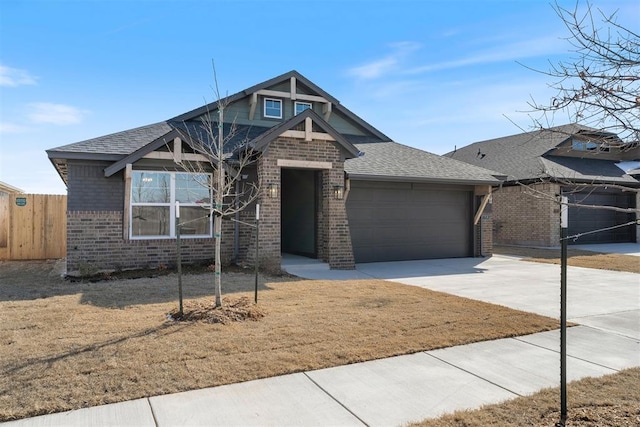 view of front facade with a garage, brick siding, concrete driveway, fence, and a front yard