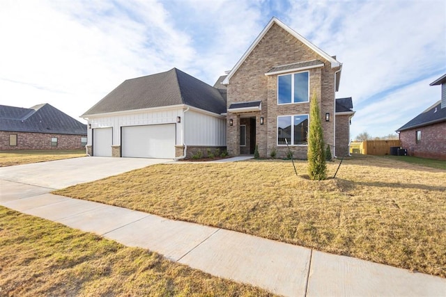 view of front of home with a front yard and a garage