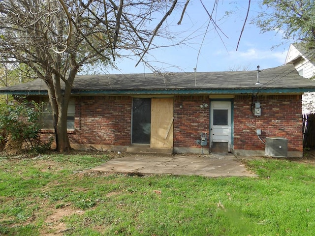 back of house featuring cooling unit, a patio area, and a yard