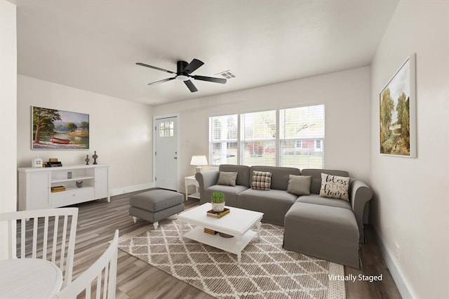 living room featuring ceiling fan and hardwood / wood-style floors