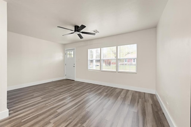 spare room with hardwood / wood-style floors and ceiling fan