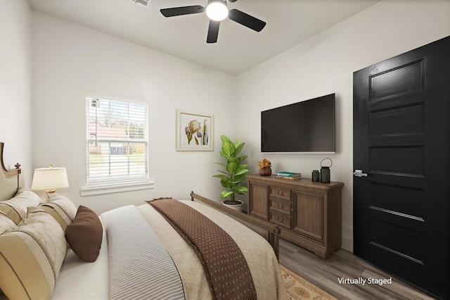 bedroom with light wood-type flooring and ceiling fan