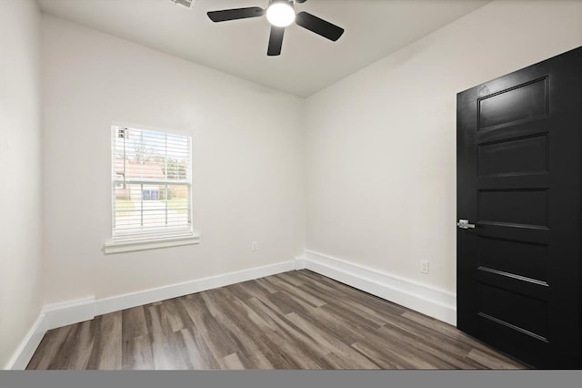 spare room with hardwood / wood-style flooring and ceiling fan