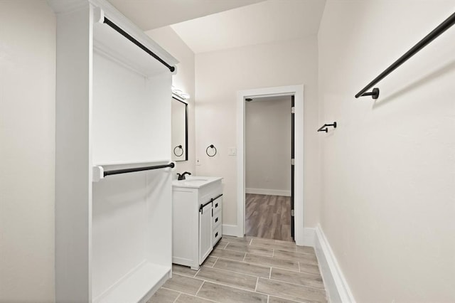 bathroom with vanity and wood-type flooring