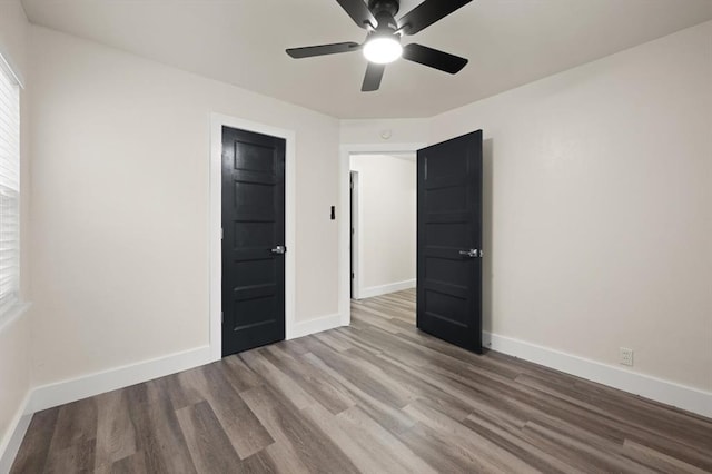 empty room featuring ceiling fan and wood-type flooring