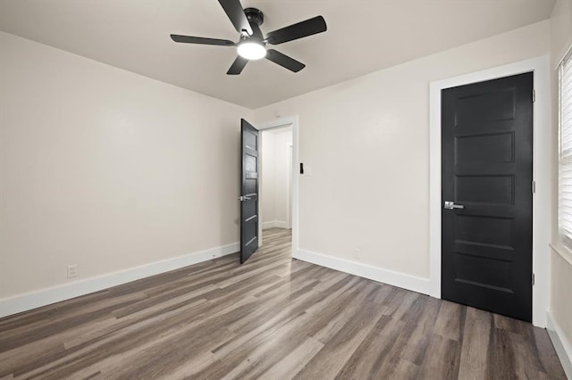 spare room with hardwood / wood-style flooring and ceiling fan