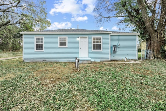 back of house with a lawn