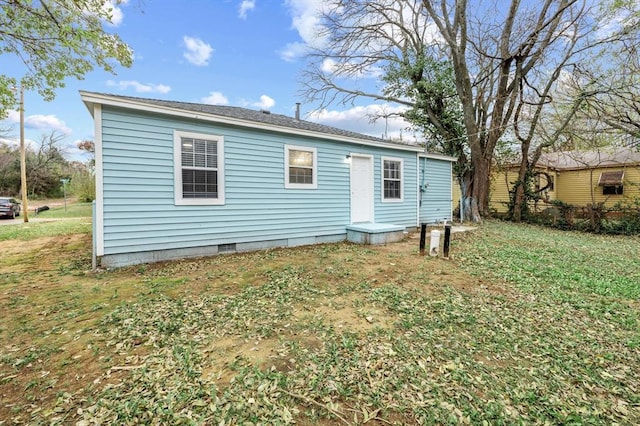 rear view of house featuring a lawn