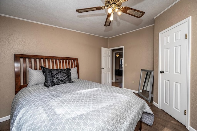 bedroom featuring ceiling fan, dark hardwood / wood-style flooring, a textured ceiling, and ornamental molding