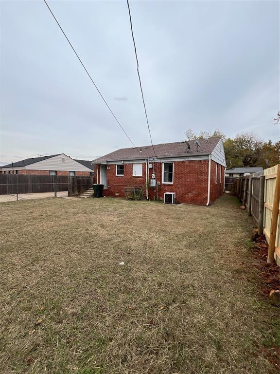 back of house with a lawn