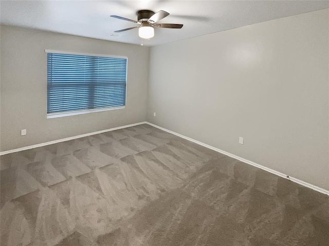 empty room featuring carpet flooring and ceiling fan