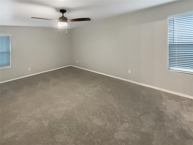 carpeted spare room featuring ceiling fan