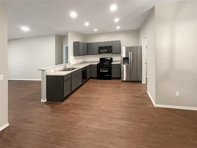 kitchen featuring sink, gray cabinets, dark wood-type flooring, and black appliances