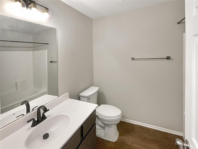 bathroom with vanity, toilet, wood-type flooring, and a shower