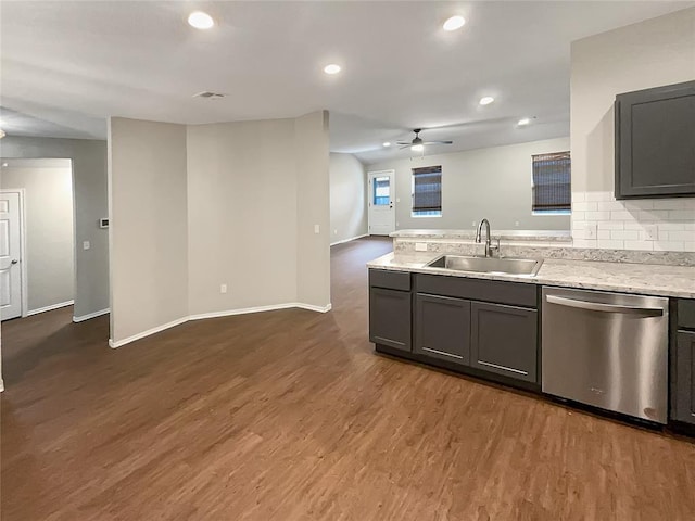 kitchen with gray cabinets, sink, stainless steel dishwasher, and dark wood-type flooring