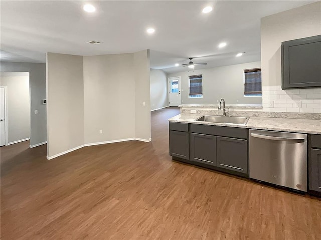 kitchen with dishwasher, wood-type flooring, gray cabinets, and sink