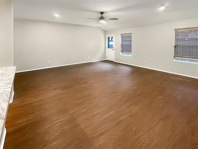 spare room with dark hardwood / wood-style floors and ceiling fan