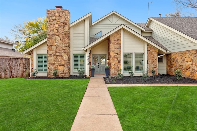 view of front facade featuring a front yard and french doors