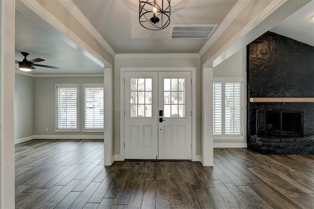 foyer entrance with crown molding and dark hardwood / wood-style flooring