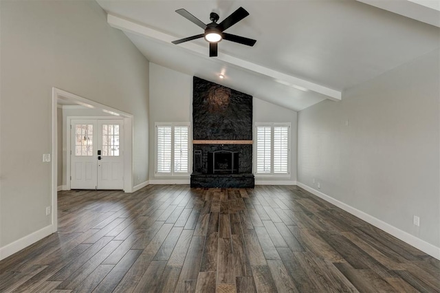 unfurnished living room with beam ceiling, ceiling fan, and a healthy amount of sunlight