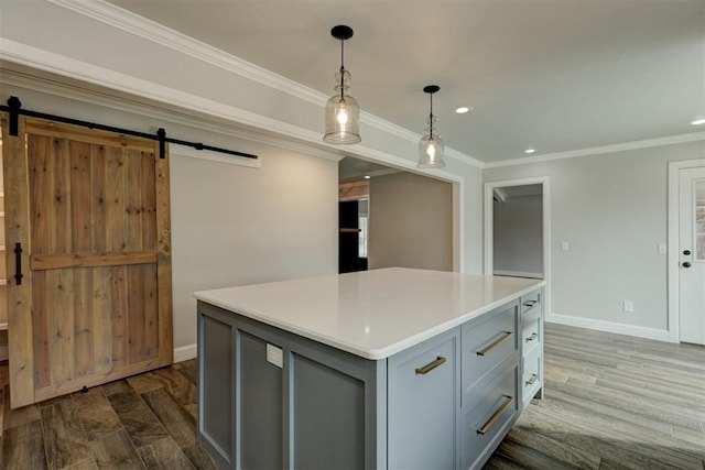 kitchen with crown molding, dark wood-type flooring, pendant lighting, a barn door, and a center island